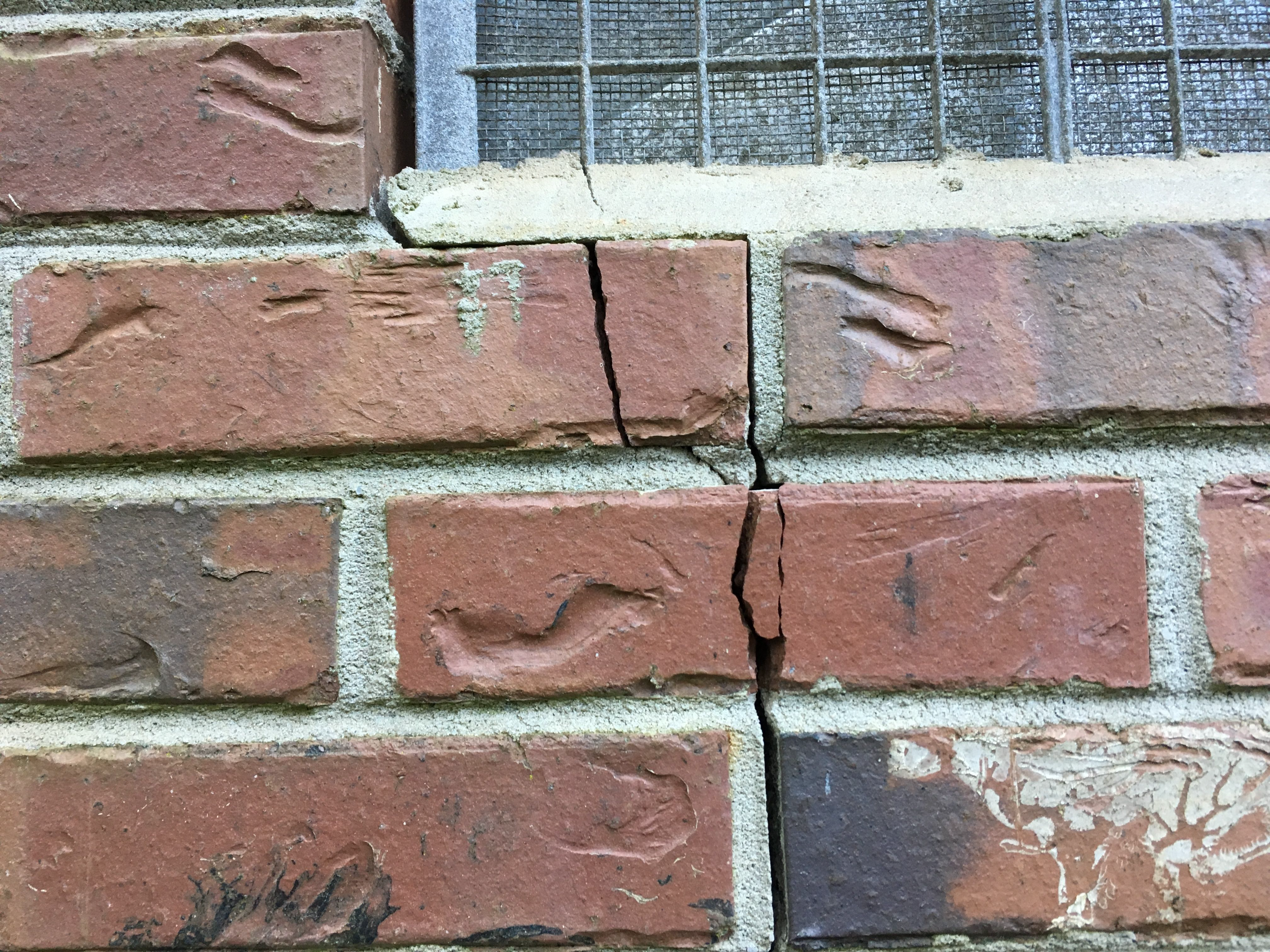 cracked exterior brick under window